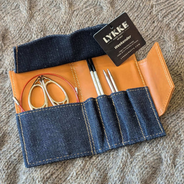 Open Lykke Weekender Knitting Needle Travel Case with scissors and needles in denim and vegan leather design.