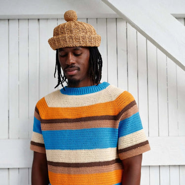 Man wearing crocheted striped sweater and hat from Hooks Out collection by Molla Mills
