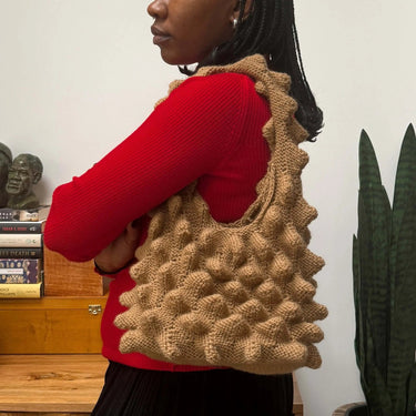 Participant holding a Romanesco Bag during the Romanesco Bag Workshop with Ranti, showcasing architectural spike design.
