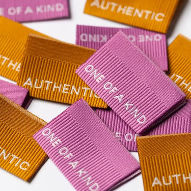 Pink and orange labels with 'One of a Kind' text on a white background