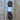A skein of dark brown yarn with a white paper label placed on a rustic wooden plank surface.