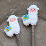 Cute llama Stitch Stoppers by Fox & Pine Stitches on knitting needles, perfect for keeping knitting projects secure.