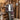 Person standing in a rustic wooden interior with a striped shawl. Tukubook knitting book