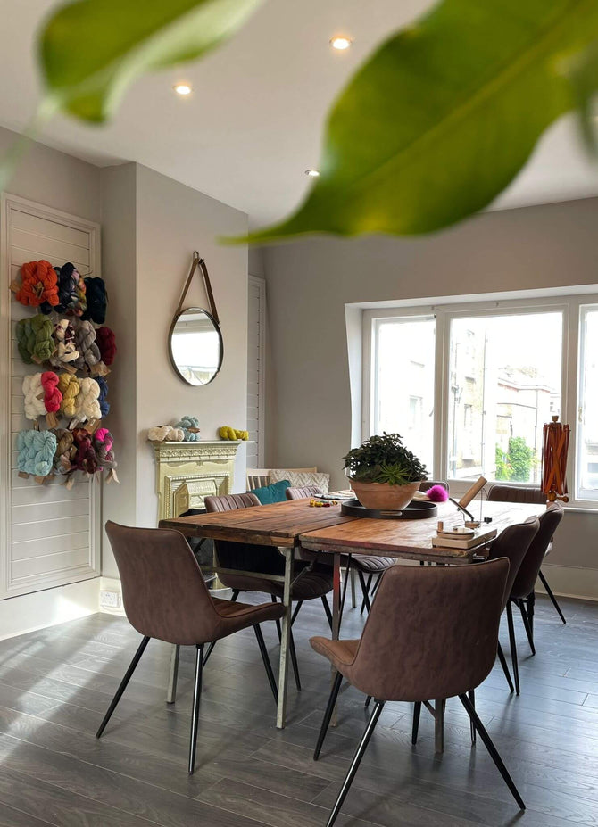 Knitting lesson area, with Crochet and knitting equipment on the table in a relaxed space.